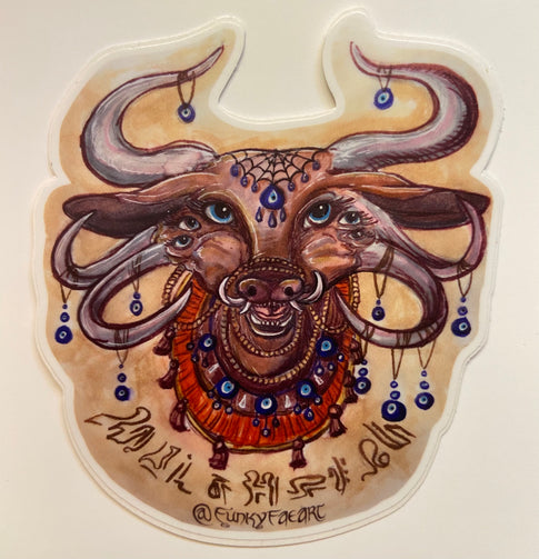 Art sticker of a brown bull with 6 eyes and 6 horns and 4 tusks. Blue glass eye “nazar” pendants hanging from each horn and more along a beaded necklace. A single blue eye bead hangs from a cobweb shaped headpiece on the forehead. Sandalwood prayer beads wrap around the bull’s nose and around its neck. Whimsical script along the bottom meant to invoke protection and guardians of dreams, but isn’t a language.