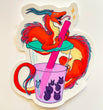 Art sticker of an orange dragon with two blue horns and pink and blue-tipped furry mane going down its back is wrapped around a plastic to-go cup of milk tea with boba. It’s front paws are holding the straw which is pink and the dragon is licking the straw happily. The milk tea drink is a taro purple color and the little black boba pearls floating in the tea are shaped like bunnies with cute faces on them