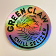 Circle sticker with arching words over the top reading “Green Claw” and arching under reading “Chill Seltzer” in the center is a rolling wave of cannabis leaves and a small UFO beaming up a cow to the right of the waves. Text and image are black with lime green text shadow. There is a rainbow holographic sheen to the whole sticker when light hits it.